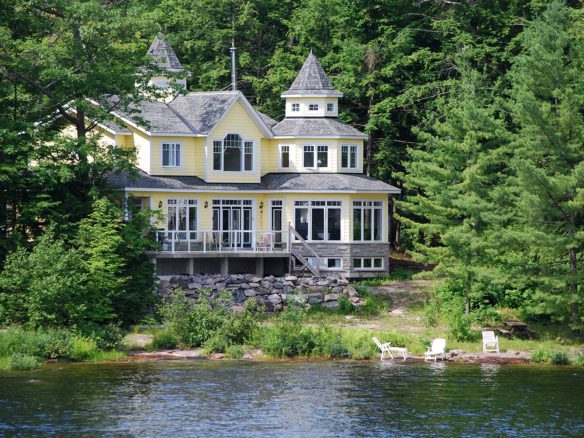 A house sitting on the side of a lake.
