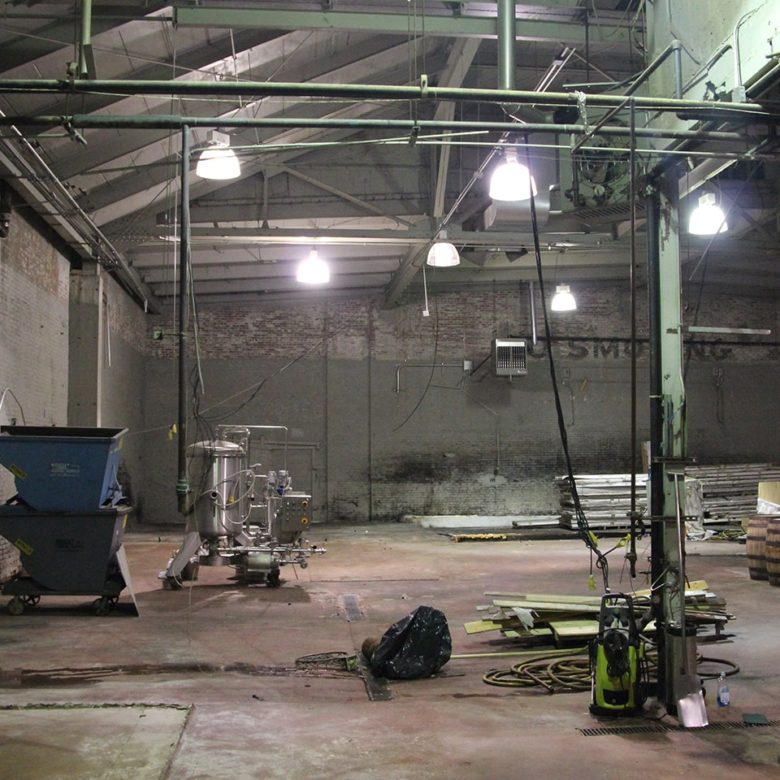 A large warehouse with many lights and machinery.