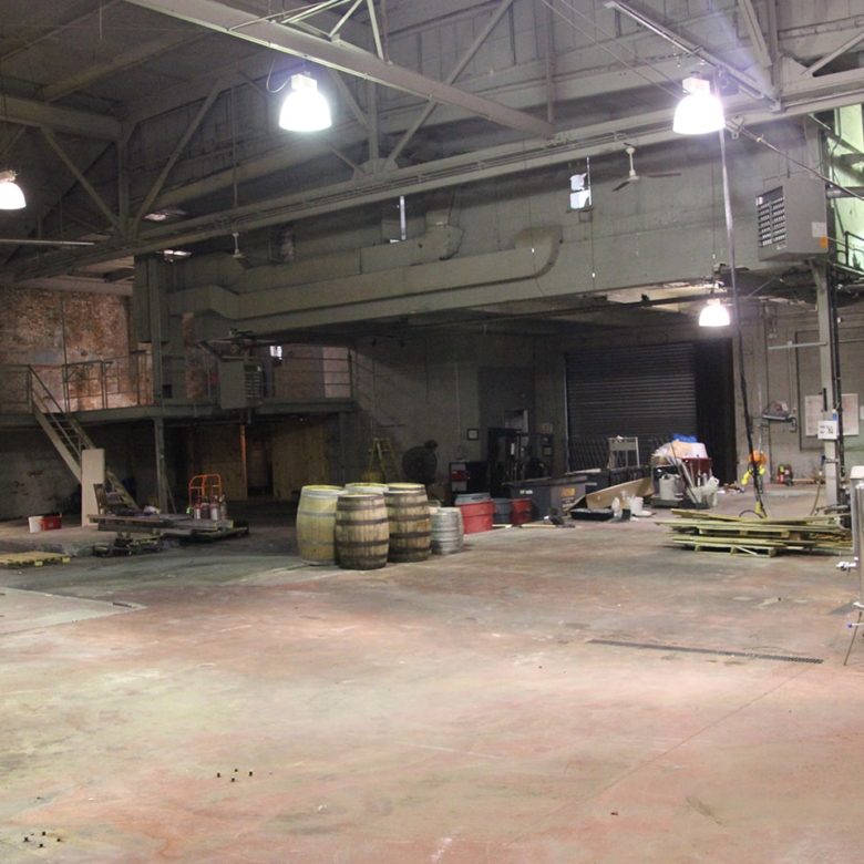A warehouse with many barrels and other items.