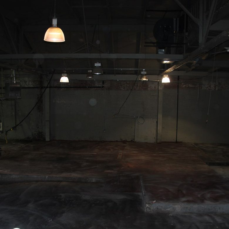 A room with lights and concrete floors in it