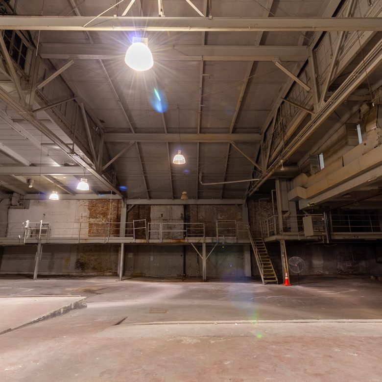 A large empty warehouse with lights on.