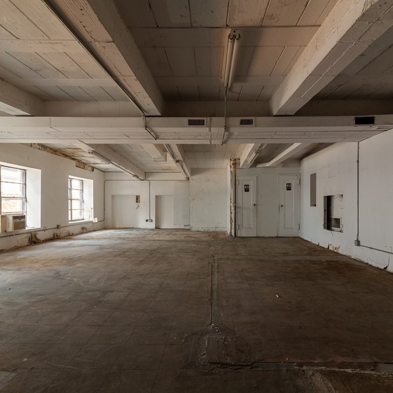 A large empty room with white walls and ceiling.