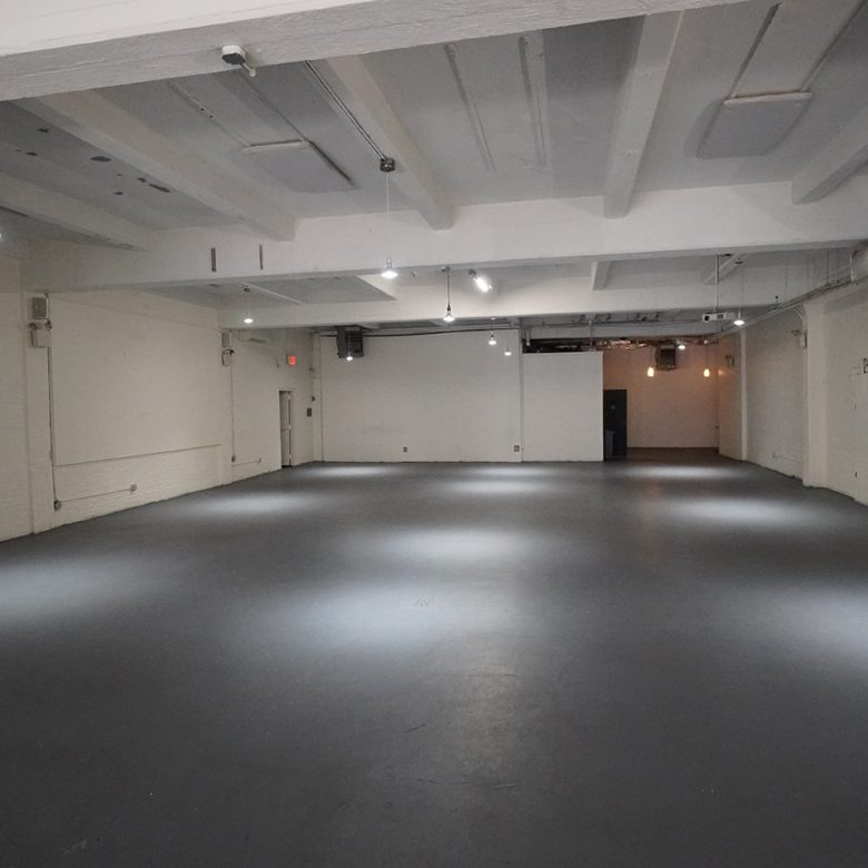 A large room with many lights and black floors.