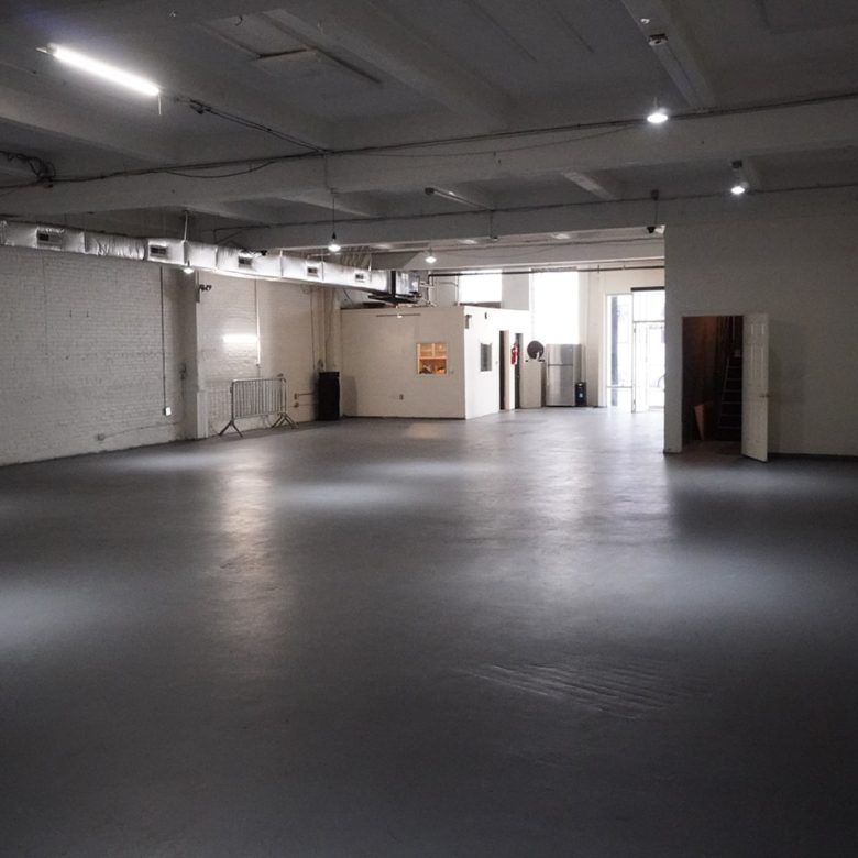 A large empty room with lights on the ceiling.