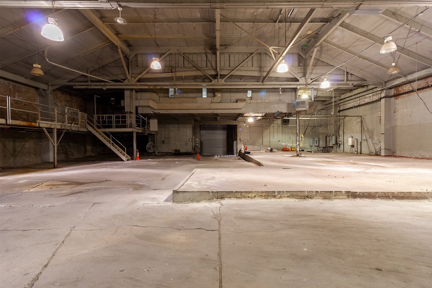 A large warehouse with concrete floors and walls.