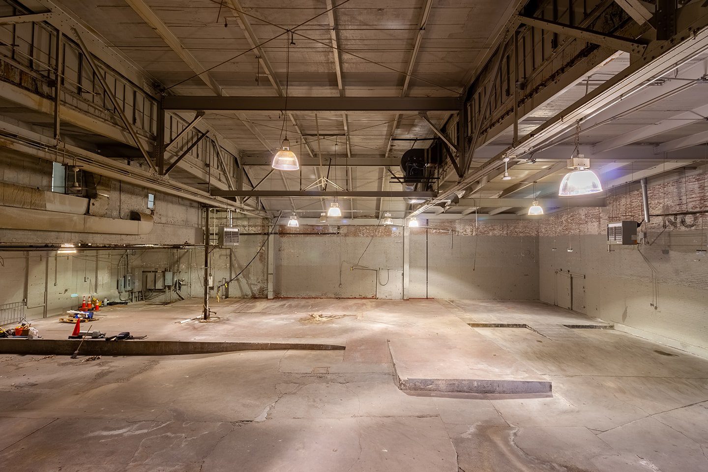 A large room with concrete floors and walls.